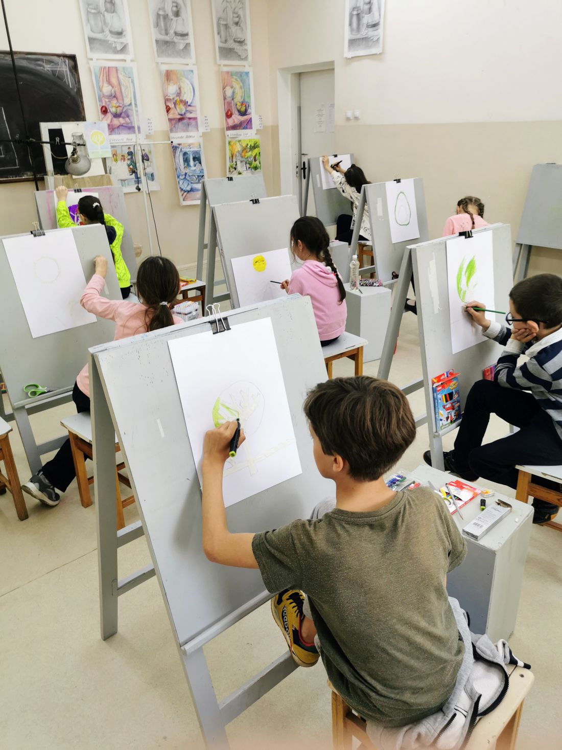 Children taking part in a creative art activity at a table
